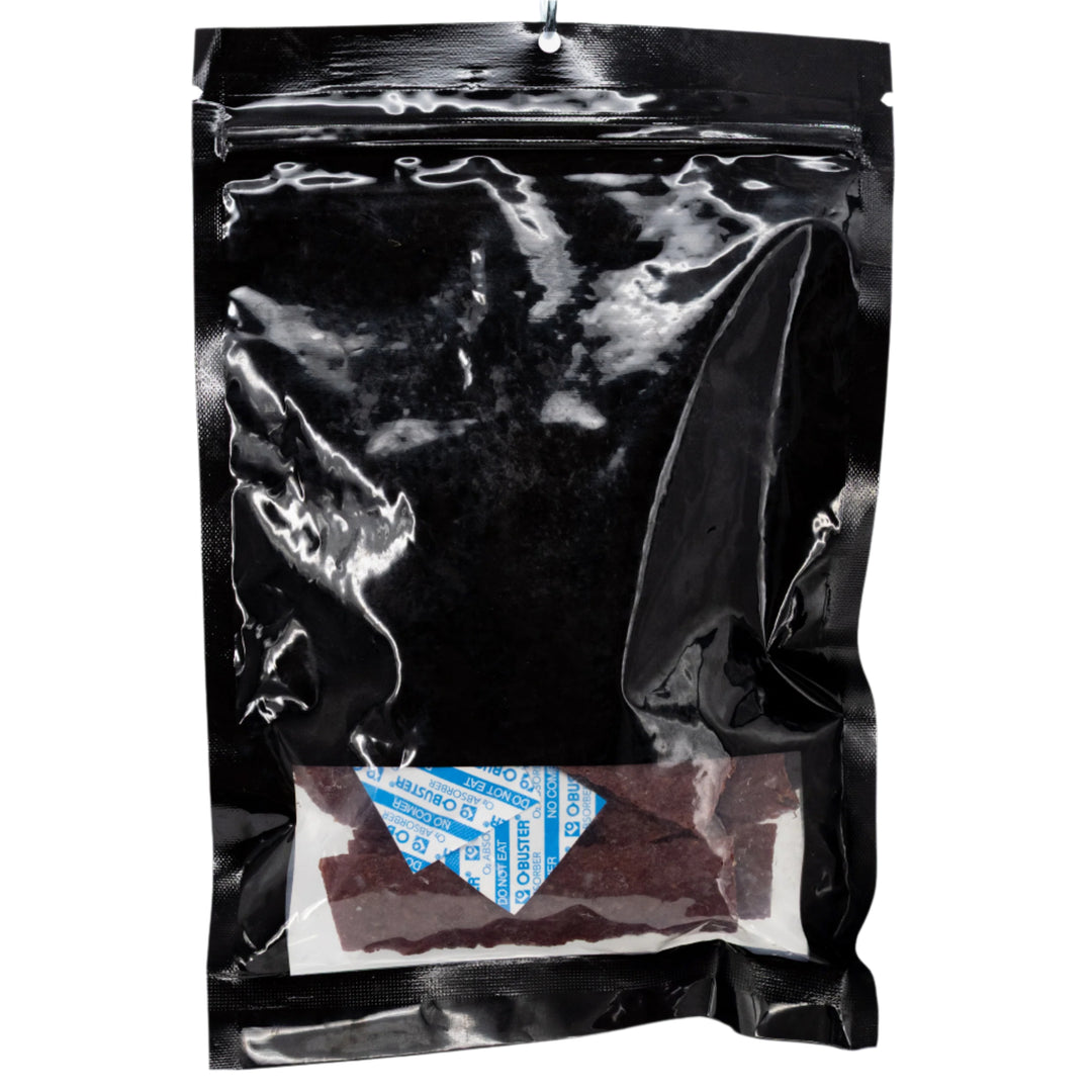 Black plastic bag with a small white label inside on a white background