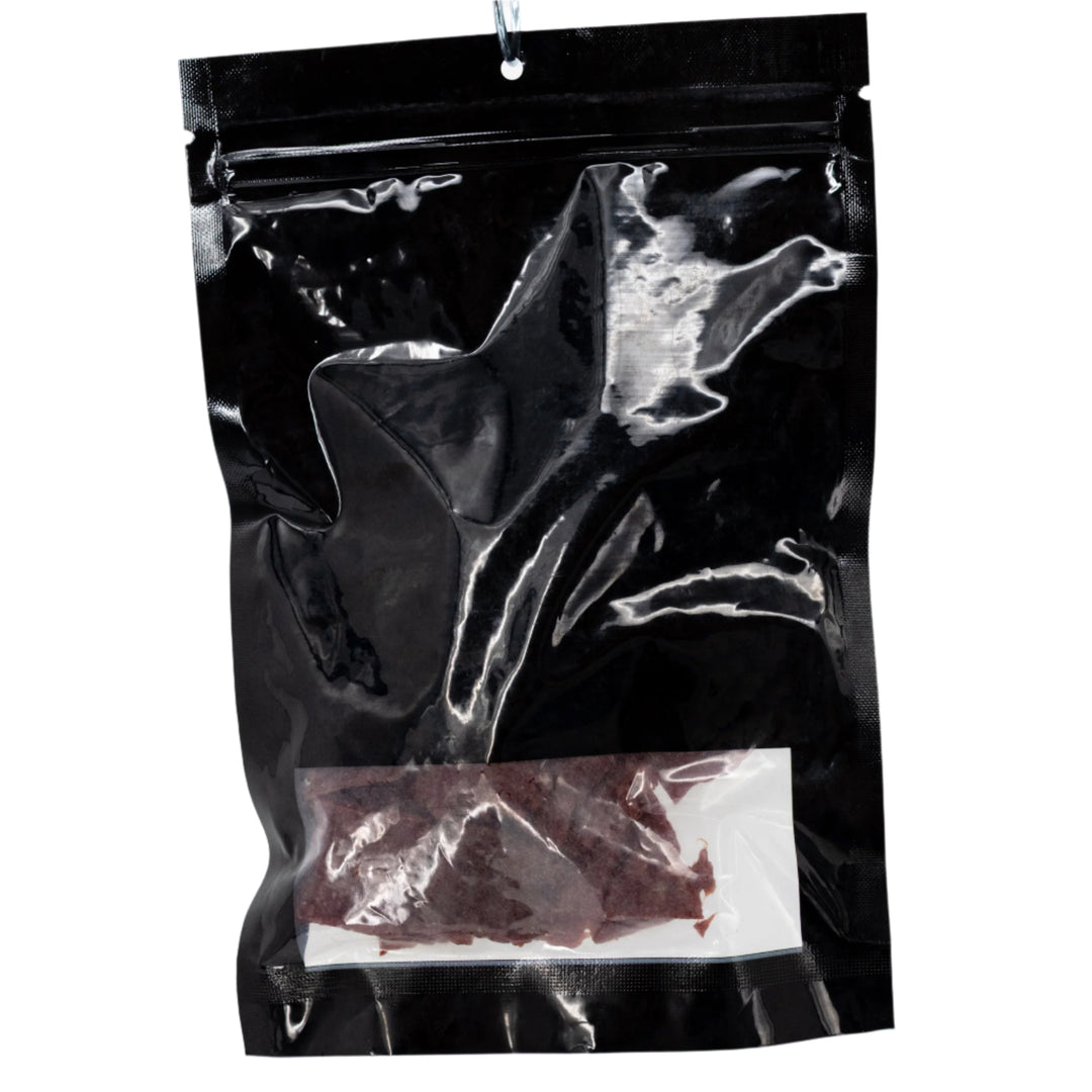 Black bag with jerky inside on a white background