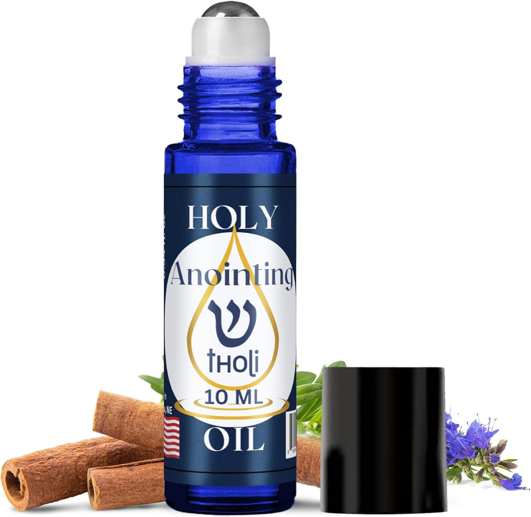Blue roller bottle labeled 'Holy Anointing Tholi Oil' with cinnamon sticks and flowers on a white background