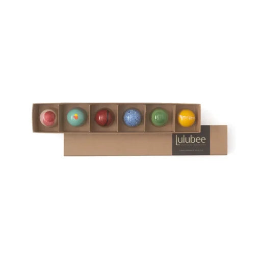 Set of colorful bath bombs in a Lulubee box on a white background