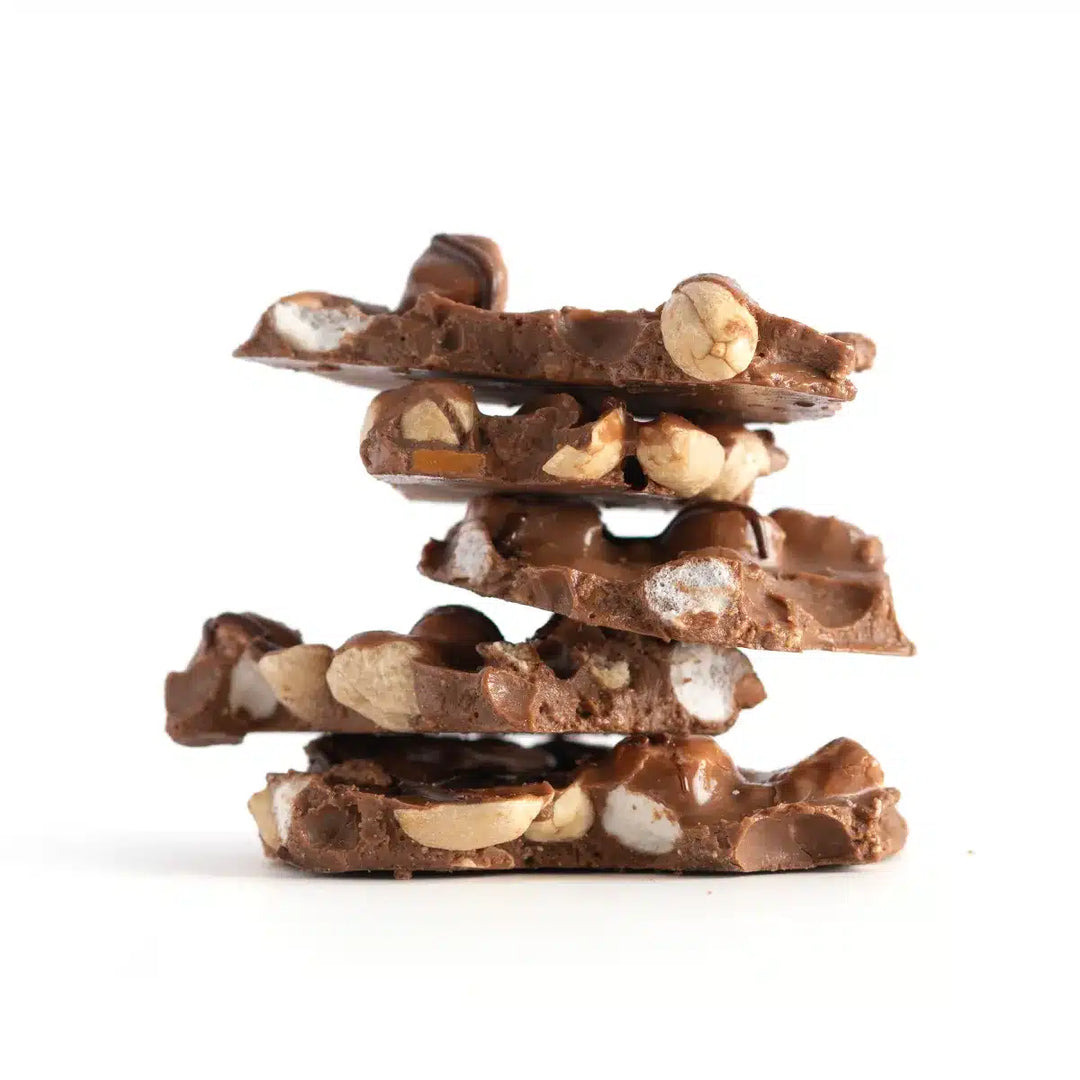 Stack of chocolate candy with nuts on a white background