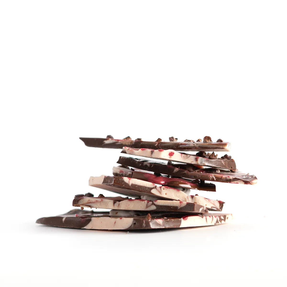 Stack of chocolate bark pieces on a white background