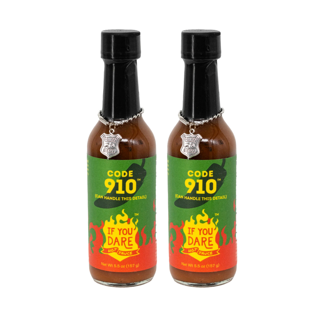 Two bottles of Code 910 hot sauce with green and red labels on a white background