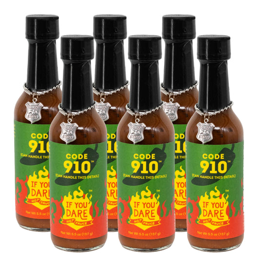 Set of six Code 910 hot sauce bottles with colorful labels on a white background