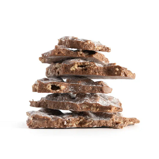 Stack of chocolate bark pieces on a white background