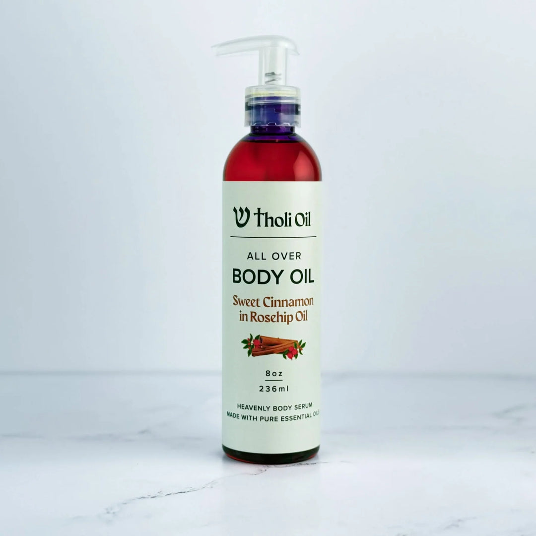 Bottle of Tholi Oil body oil on a white background