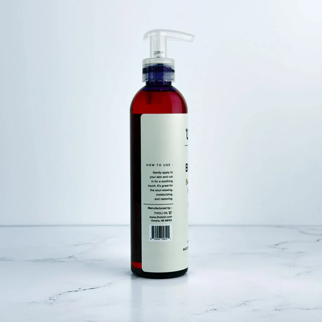 Bottle with pump and label on a white marble surface