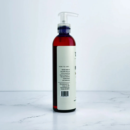 Bottle with pump and label on a white marble surface