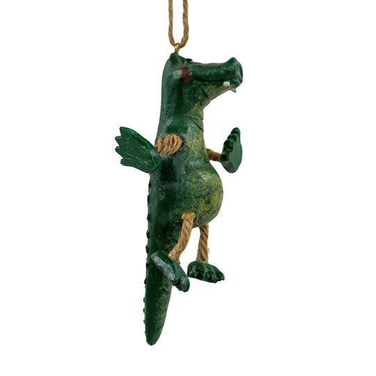 Green dragon-shaped ornament hanging on a white background