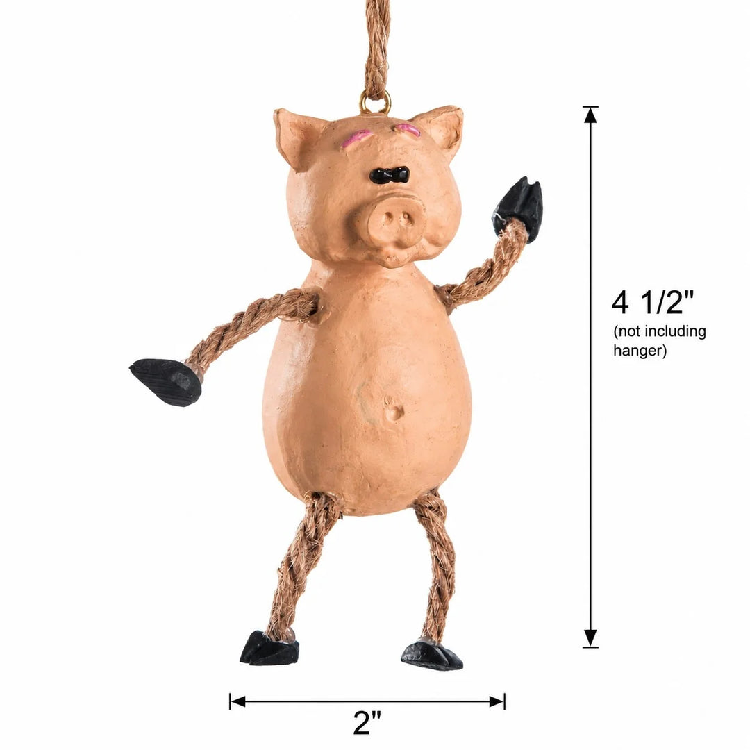 A hanging pig decoration with a tan body, rope arms and legs, black hooves, and a black nose, shown on a white background with dimension labels indicating 4 1/2 inches height and 2 inches width.