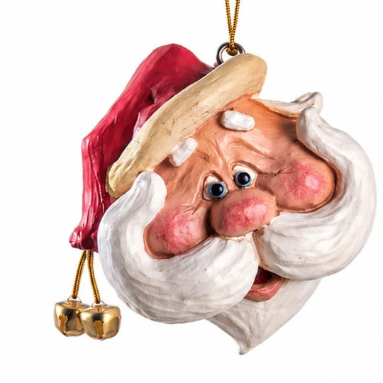 A novelty Christmas ornament shaped like a Santa Claus face with a red hat, white beard, pink cheeks, and small gold bells hanging below, shown on a plain white background.