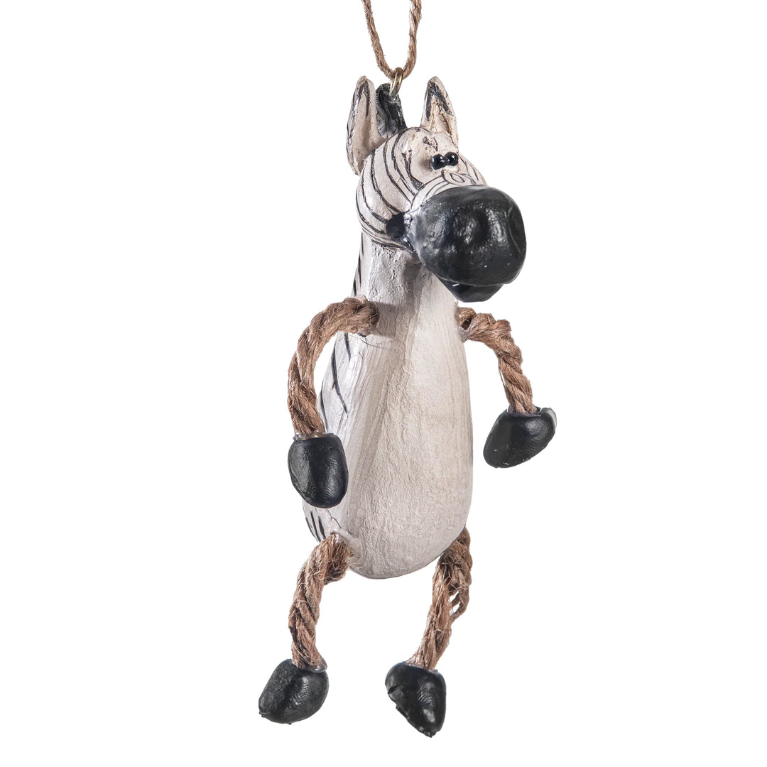 A hanging zebra-shaped ornament or decoration with a distressed off-white body, black-and-white striped head, rope arms and legs, and black hooves, shown against a plain white background.