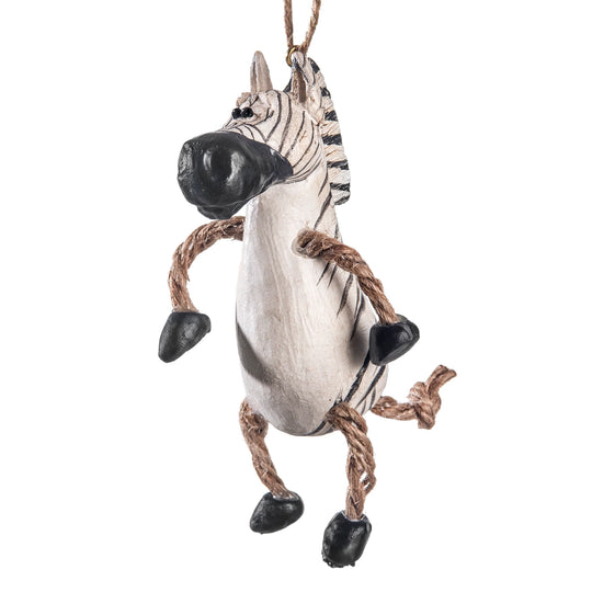 A hanging zebra-shaped ornament or decoration with a white body, black stripes, black hooves, and rope legs on a plain white background.