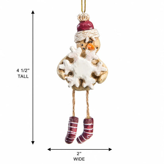 A hanging snowman ornament with a red hat, white scarf and snowflake body, orange carrot nose, and red-and-white striped socks, shown with dimension arrows labeled 4 1/2 inches tall and 2 inches wide on a white background.