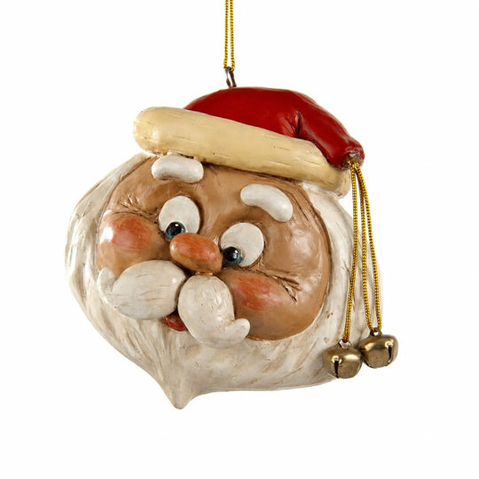 A hand-painted Christmas ornament shaped like Santa Claus' head, featuring a red hat with a beige trim, a brown face, white beard, and gold hanging cord with small bells.