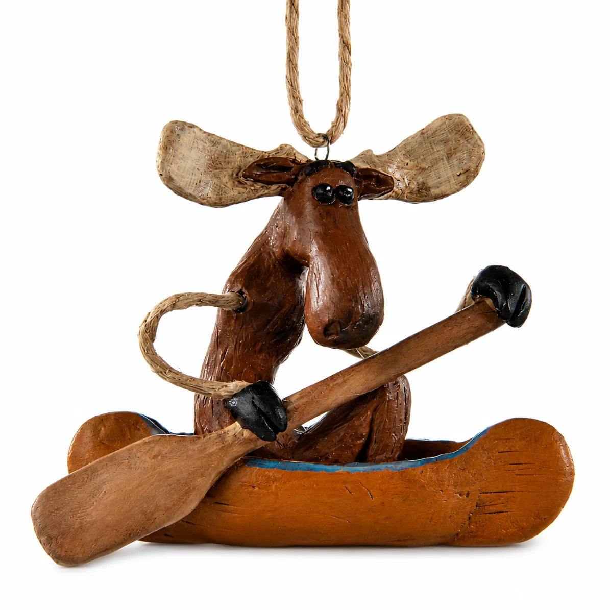 A rustic wooden ornament depicting a moose sitting in a canoe and holding a paddle, with a hanging twine loop at the top, shown on a plain white background.