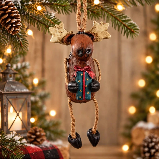 Moose with gift ornament hanging from Christmas Tree