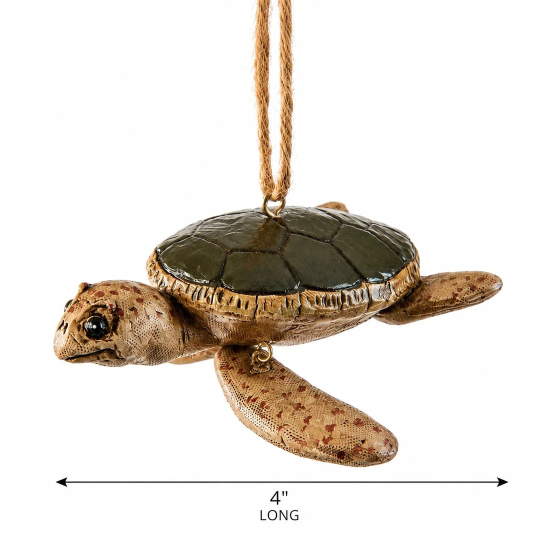 A sea turtle hanging ornament with a textured tan and brown shell and head, a dark green shell top, and a natural jute hanging string. A dimension line at the bottom indicates the ornament is 4 inches long.