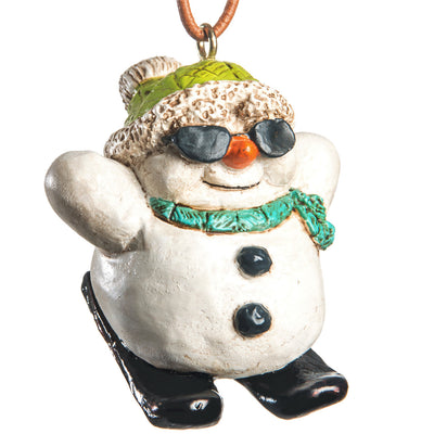 Short fat snowman wearing sunglasses, bright green stocking hat and turquoise scarf on black skis, shown on a white background