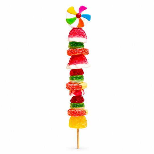 Colorful beach ball candy kabob featuring a beach ball shaped gummy topper ans assorted fruit-flavored candies on a wooden skewer, isolated on a white background.