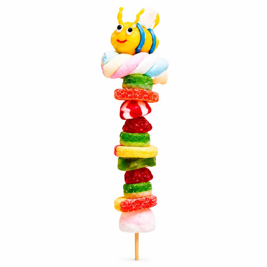Bee candy kabob featuring a yellow bee-shaped gummy topper and assorted colorful gummies on a wooden skewer against a clean white background.