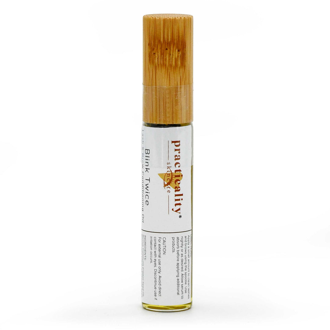 A small cylindrical bottle of PractiQuality Blemk Twixce essential oil with a bamboo cap and a white label, shown on a clean white background.