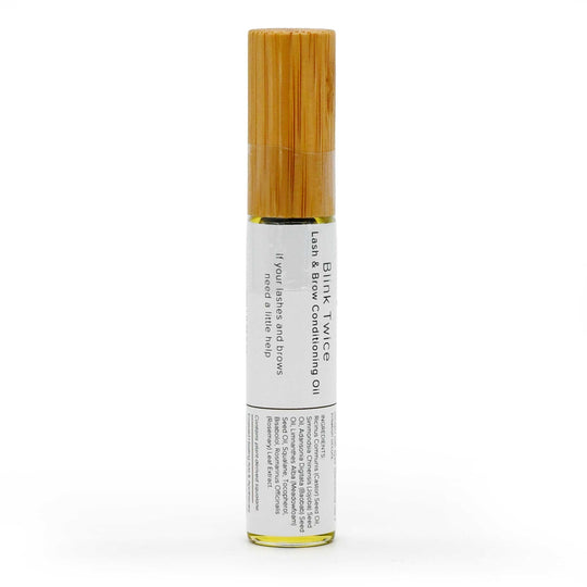 A single roll-on bottle of Blink Twice Lemon & Borneo Conditioning Oil with a light bamboo cap and a white label, shown on a clean white background.