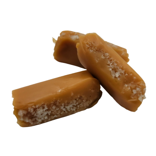 Two pieces of caramel candy on a white background