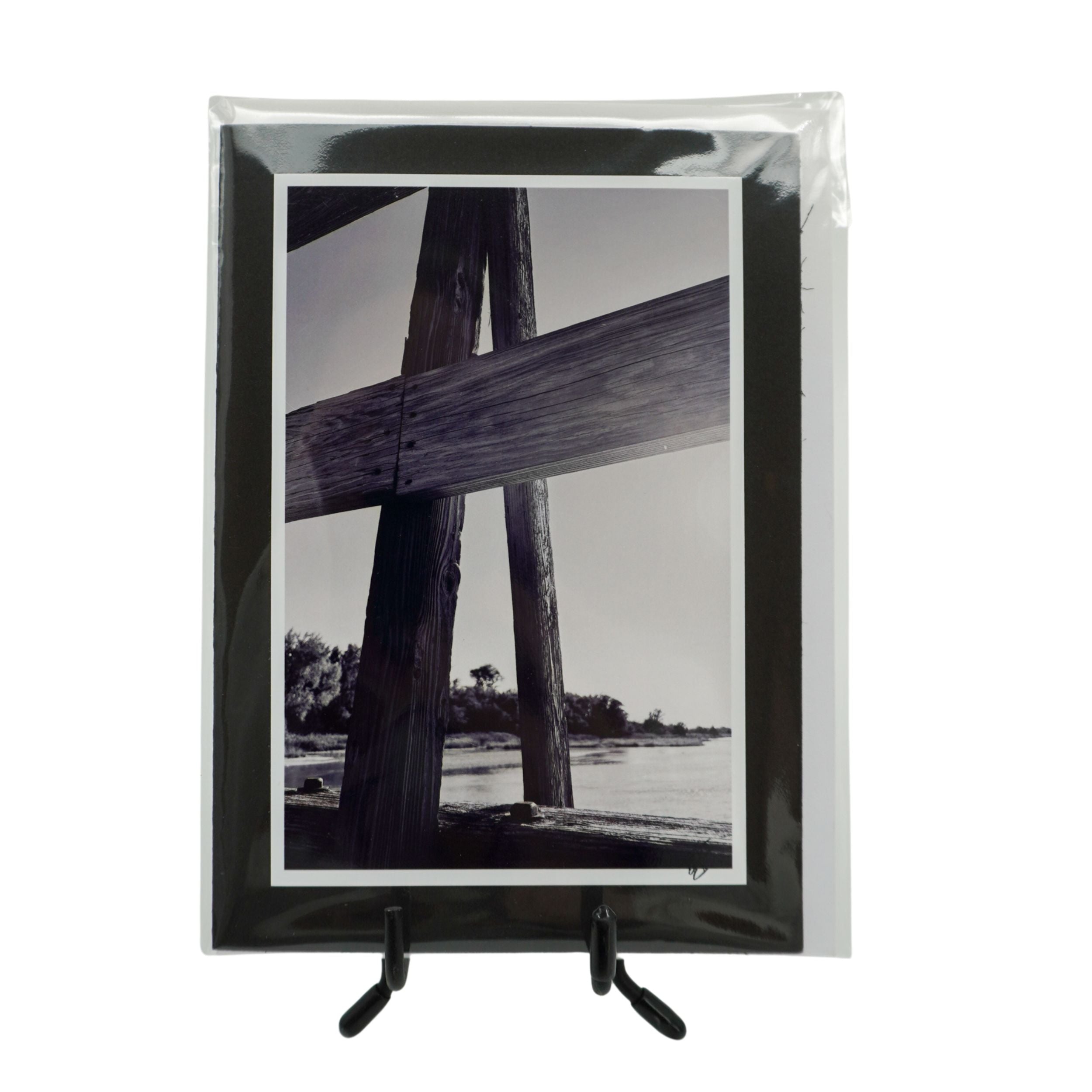 Packaged blank notecard featuring a blank and white photograph of a wooden bridge