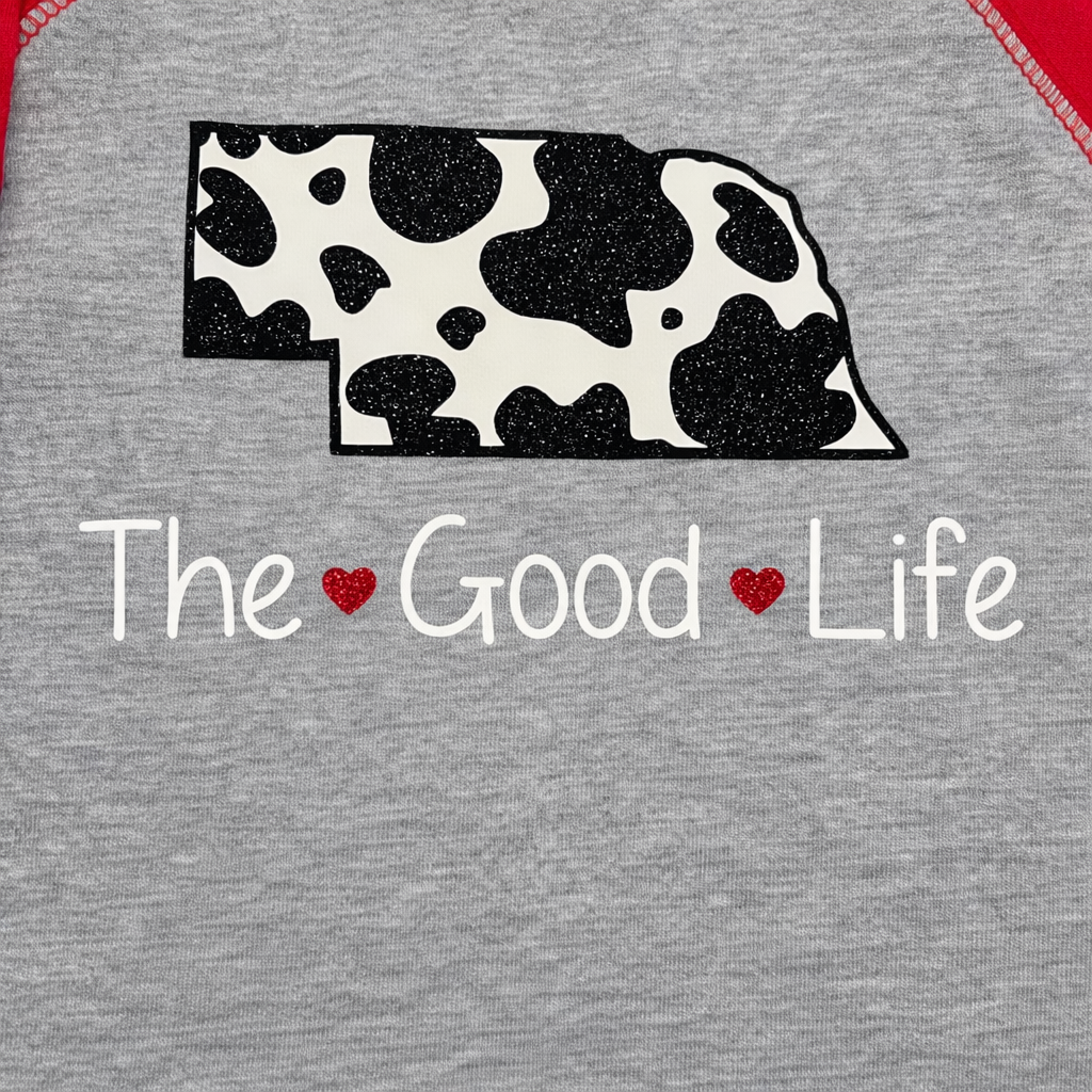 Gray t-shirt with cow print Nebraska shape and 'The Good Life' text 