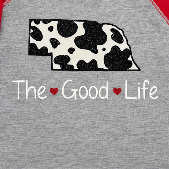 Gray t-shirt with cow print Nebraska shape and 'The Good Life' text 