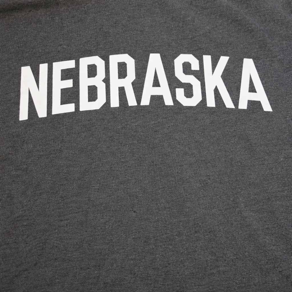 Gray t-shirt with 'NEBRASKA' printed in white on a dark background