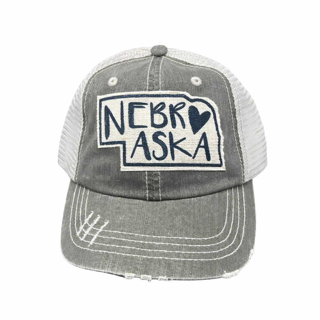 Gray and white trucker hat with 'NEBRASKA' text and heart design on a white background