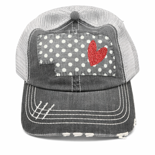Trucker hat with polka dot patch and red heart on a white background