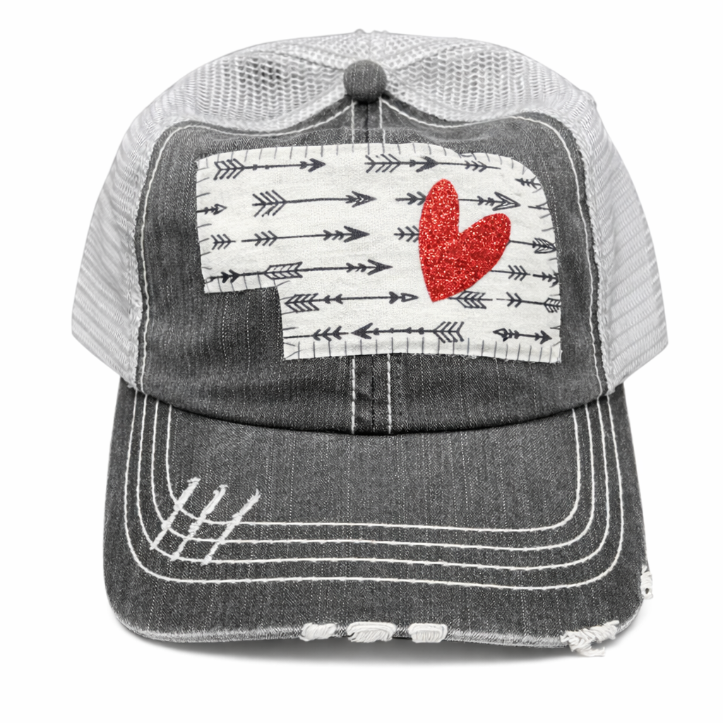 Trucker hat with a red heart and arrow pattern on a white background