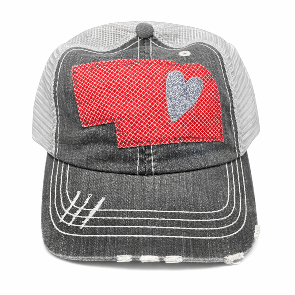 Gray trucker cap with red and gray heart design on a white background