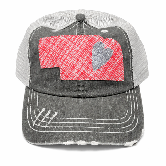 Trucker hat with red plaid pattern and gray heart on a white background
