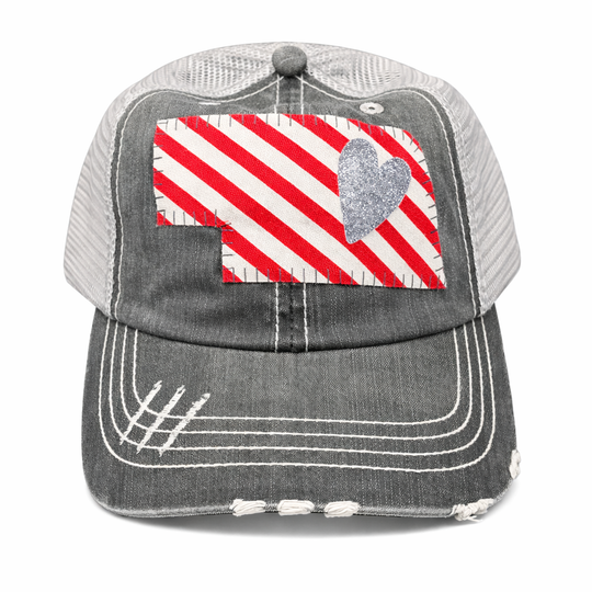 Gray cap with red and white striped pattern and heart design on a white background