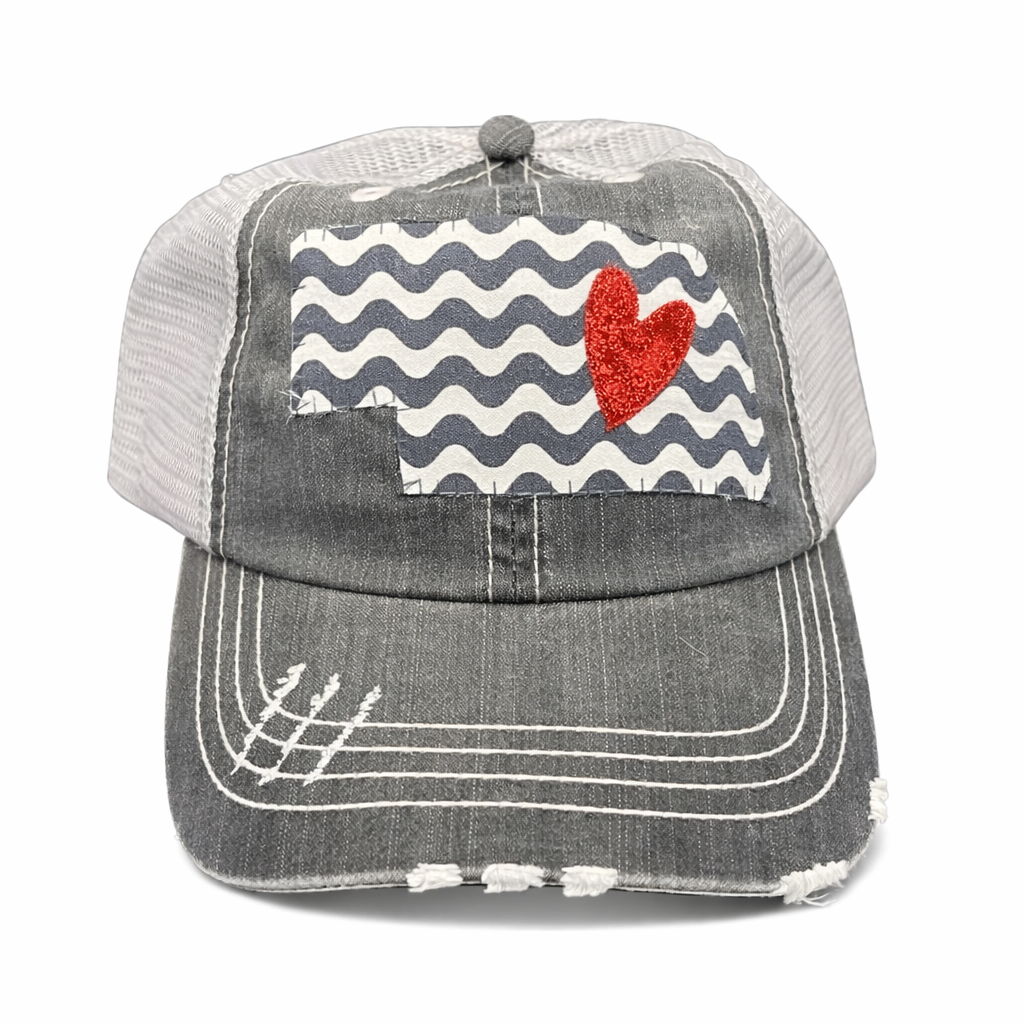 Gray cap with red heart and wavy pattern on a white background