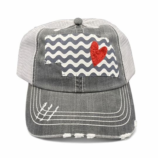 Gray cap with red heart and wavy pattern on a white background