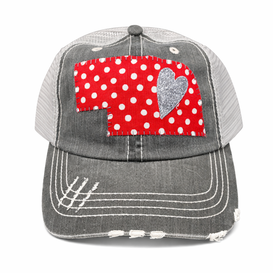 Gray cap with a red polka dot patch featuring a heart on a white background