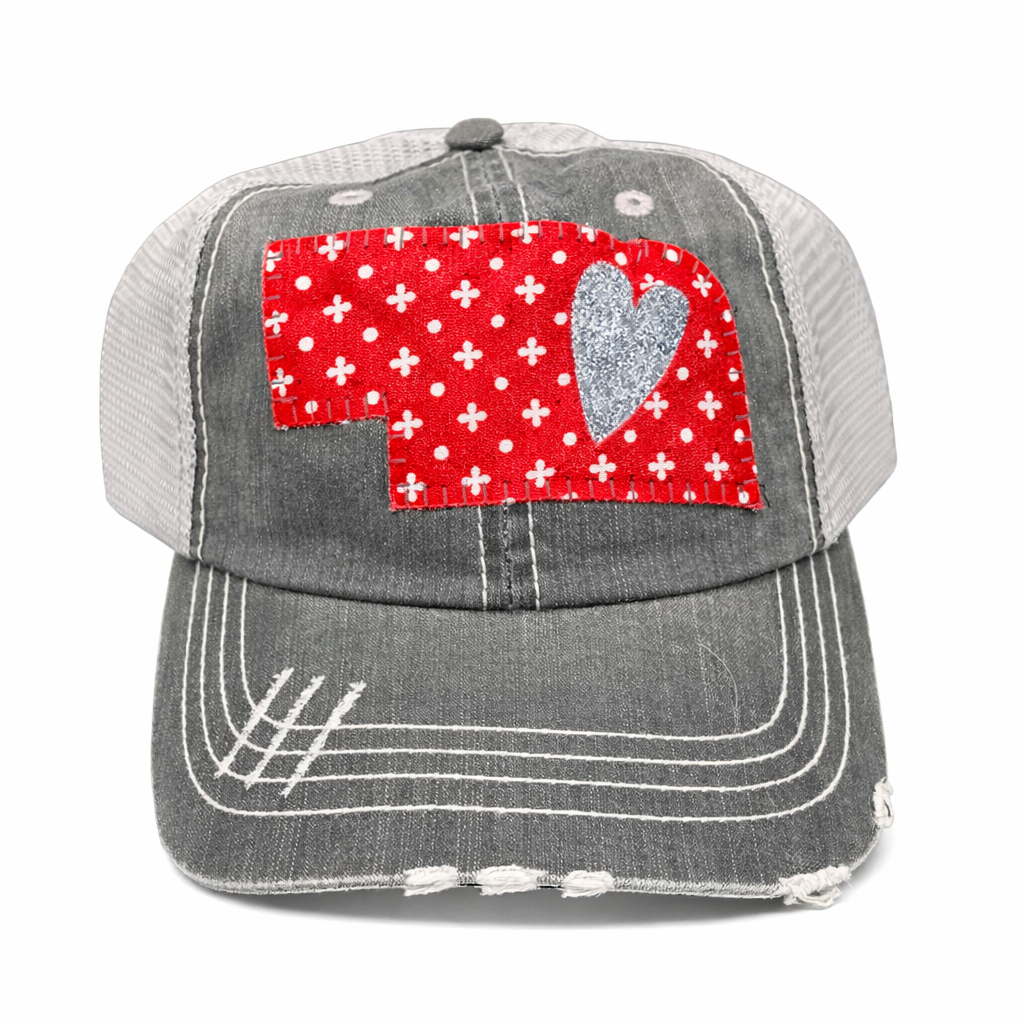 Gray cap with a red heart and white cross pattern on a white background