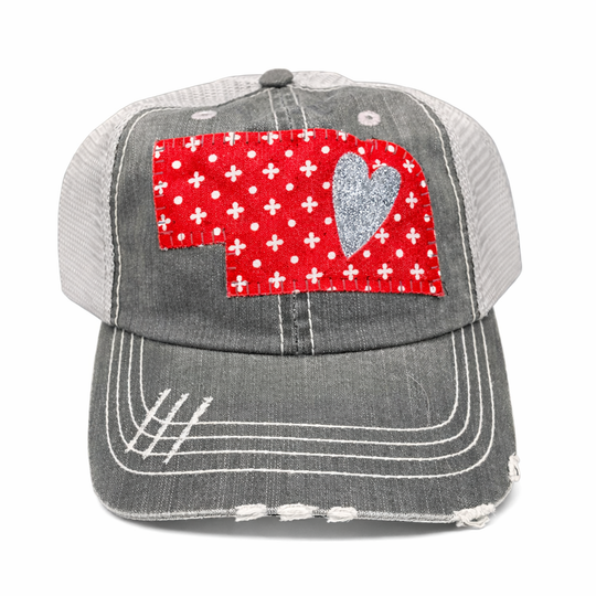 Gray cap with a red heart and white cross pattern on a white background