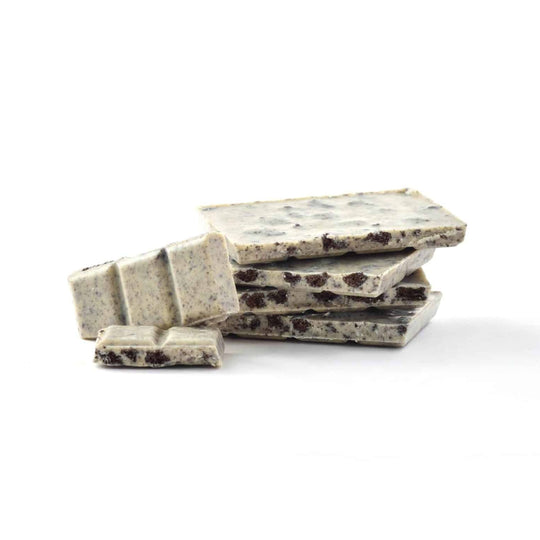 Stack of white chocolate cookies and cream chocolate bar on a white background