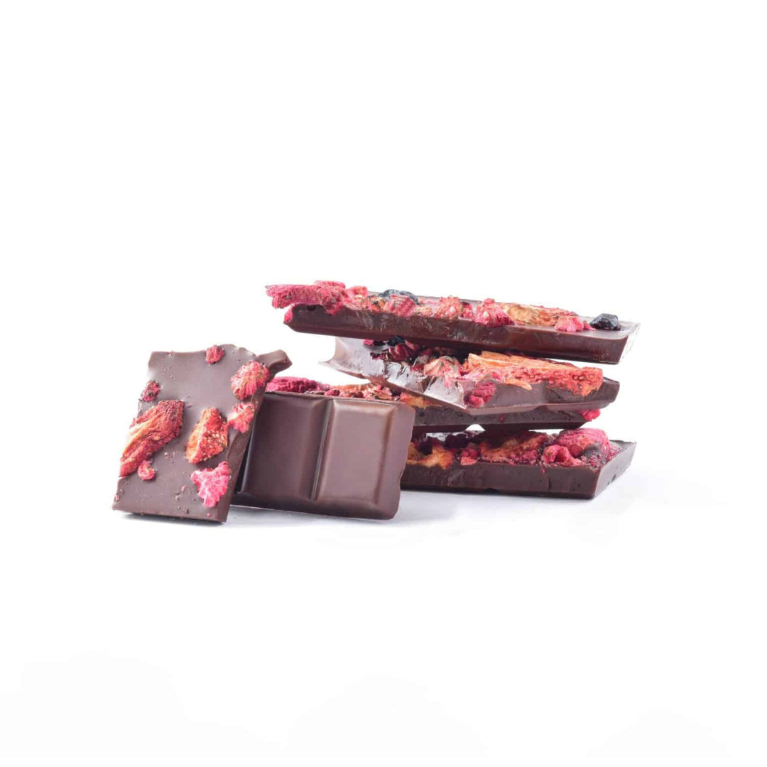 Chocolate bars with dried berry pieces on a white background
