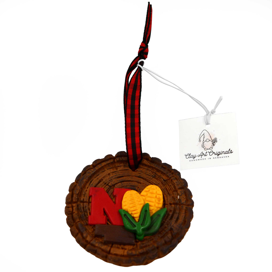 Decorative ornament with 'N' on a piece of wood and heart design on a white background