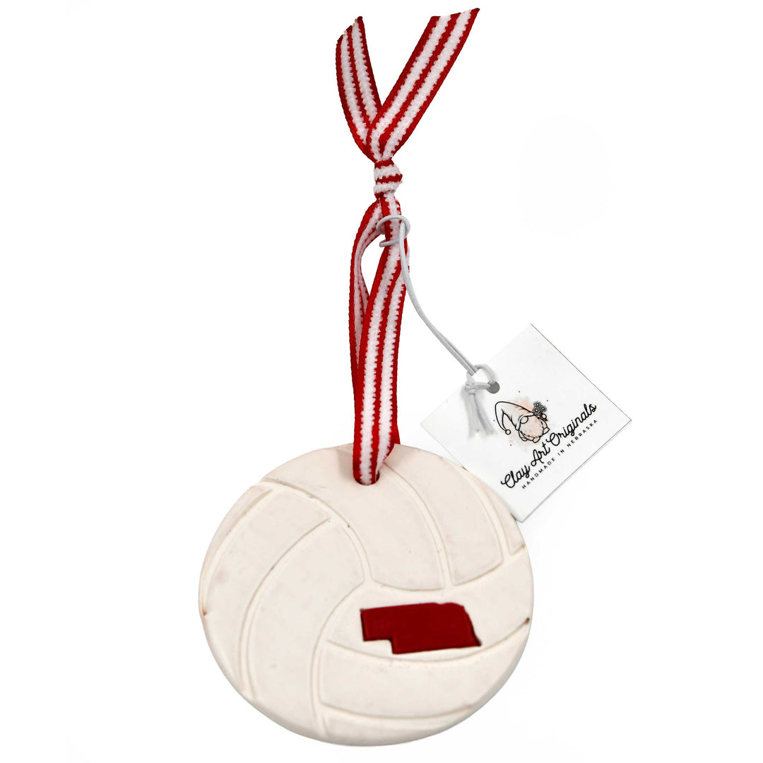 Volleyball-shaped ornament with Nebraska outline on a white background