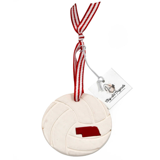 Volleyball-shaped ornament with Nebraska outline on a white background