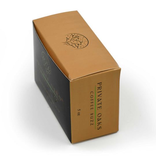 Brown and black coffee packaging with 'Private Oaks Coffee Buzz' branding on a white background