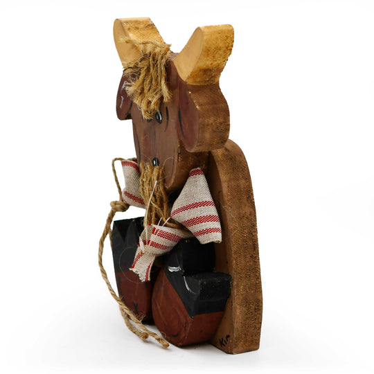 Wooden goat figurine with a blanket on a white background